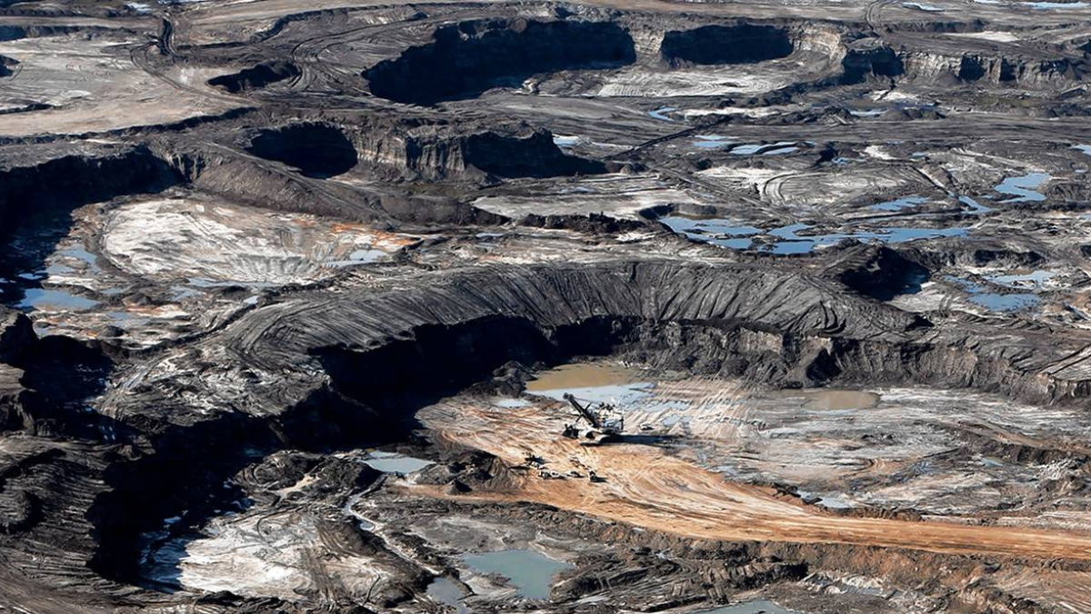 Aerial oil sands mine showing tailings areas linked to cleaner bitumen recovery research