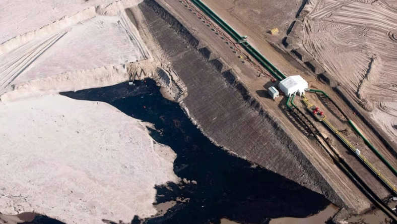 Aerial view of oil sands tailings area with monitoring infrastructure and pipelines