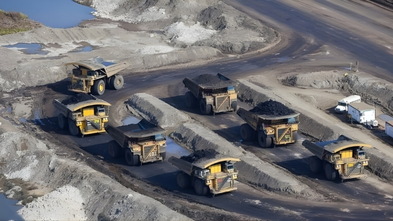Oil sands mining trucks transporting material at open-pit site