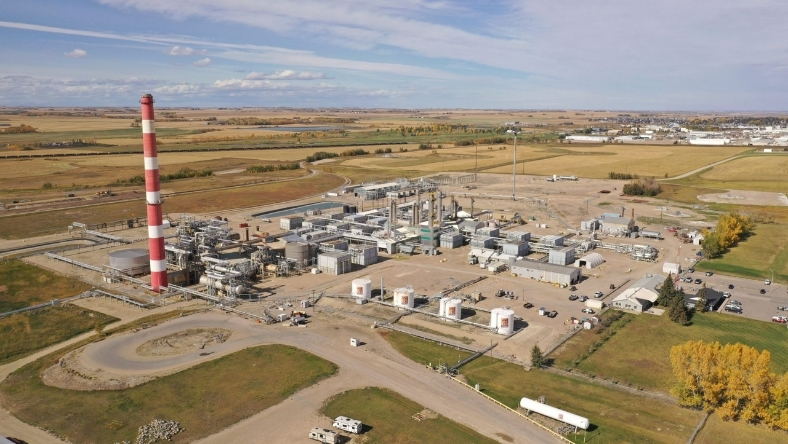 Industrial processing facility with red and white smokestack