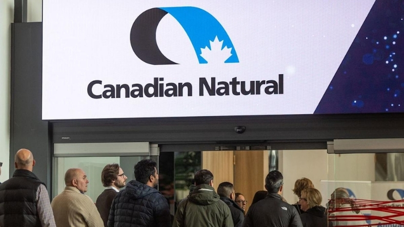 Canadian Natural logo displayed above building entrance with people below