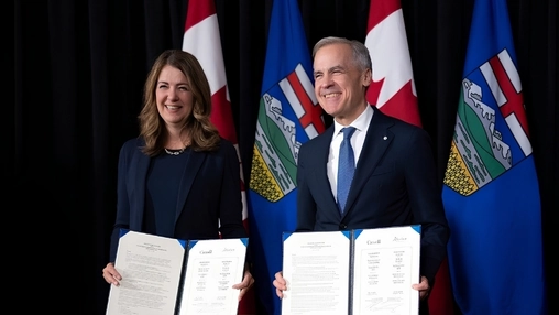 Two officials holding signed documents in front of Canadian flags